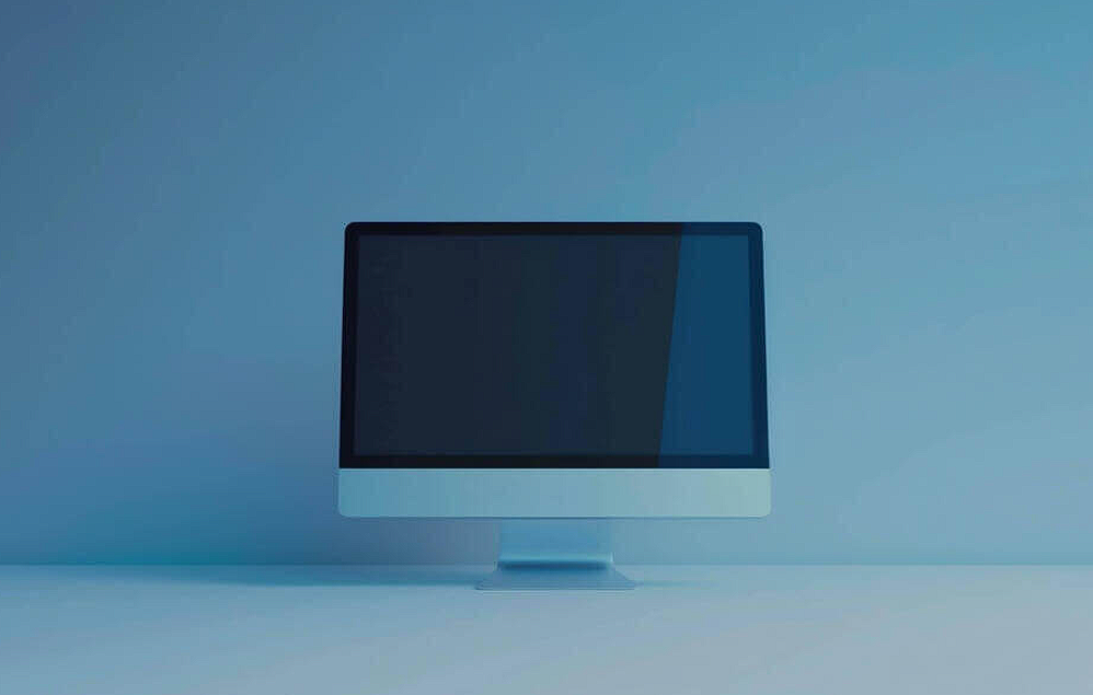 empty computer monitor on blue table