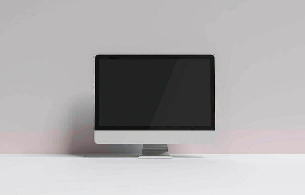 inactive computer monitor on white tabletop
