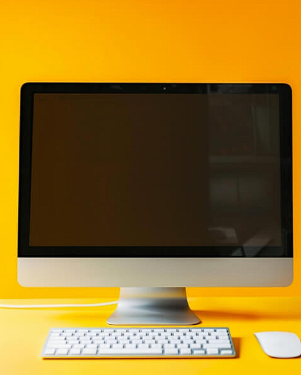 modern desktop computer setup on orange background