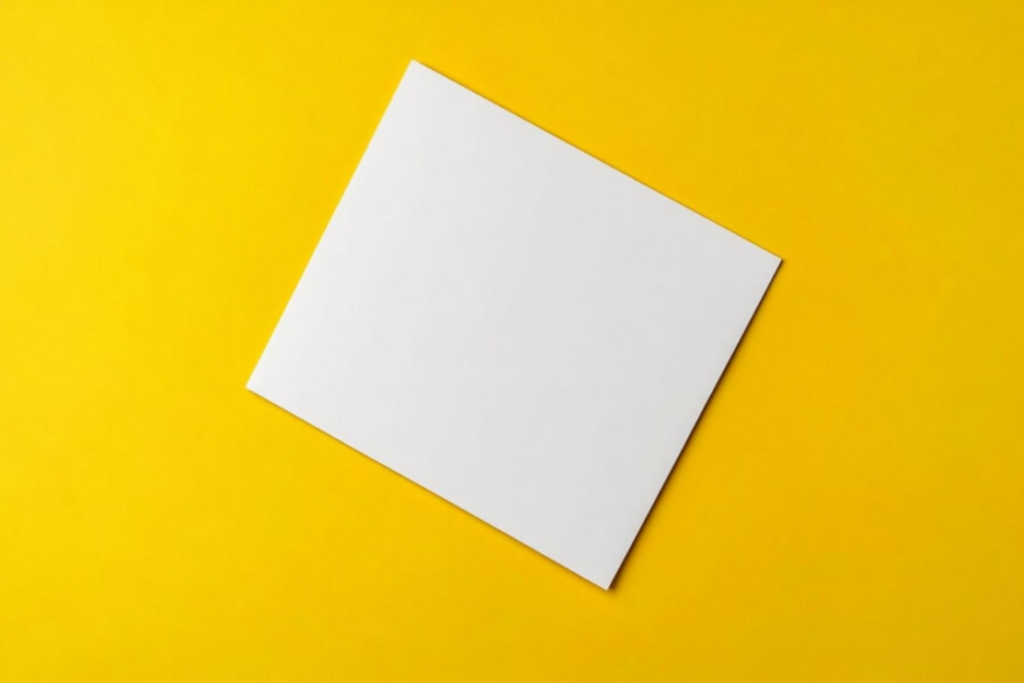 blank white paper on yellow background