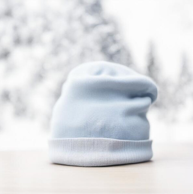 Beanie Mockups blue beanie hat on wooden table with snow covered trees